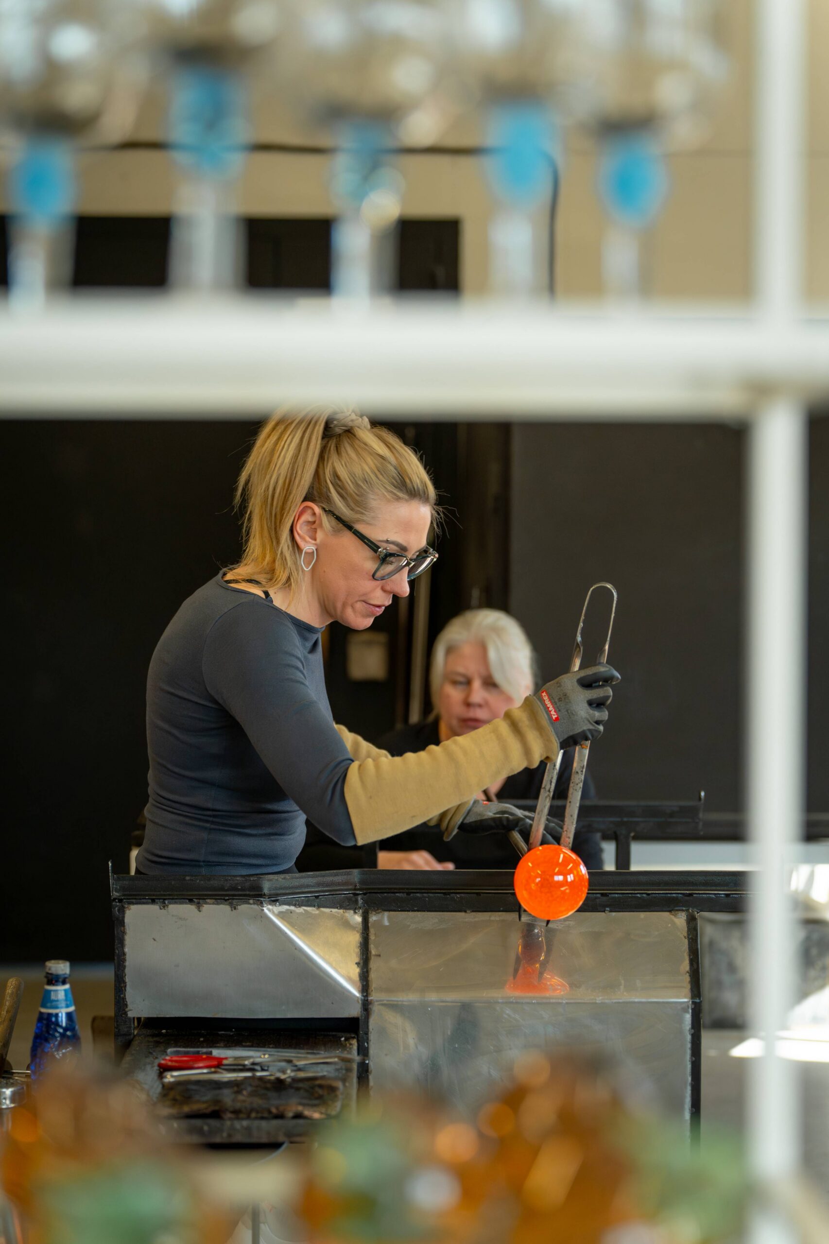 Shaping the glass object with jacks — making the neck for a flycatcher.